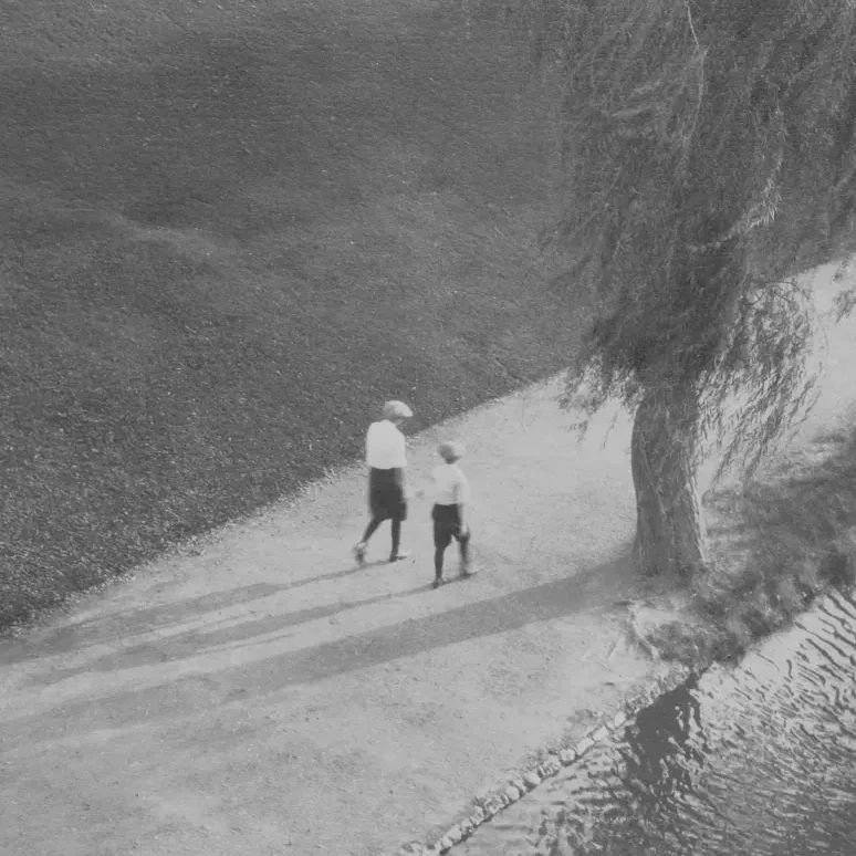 a woman and a child, from afar